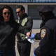 A person receives a protective mask from a member of the New York City police department on May 13, 2020 in the Brooklyn borough in New York City.